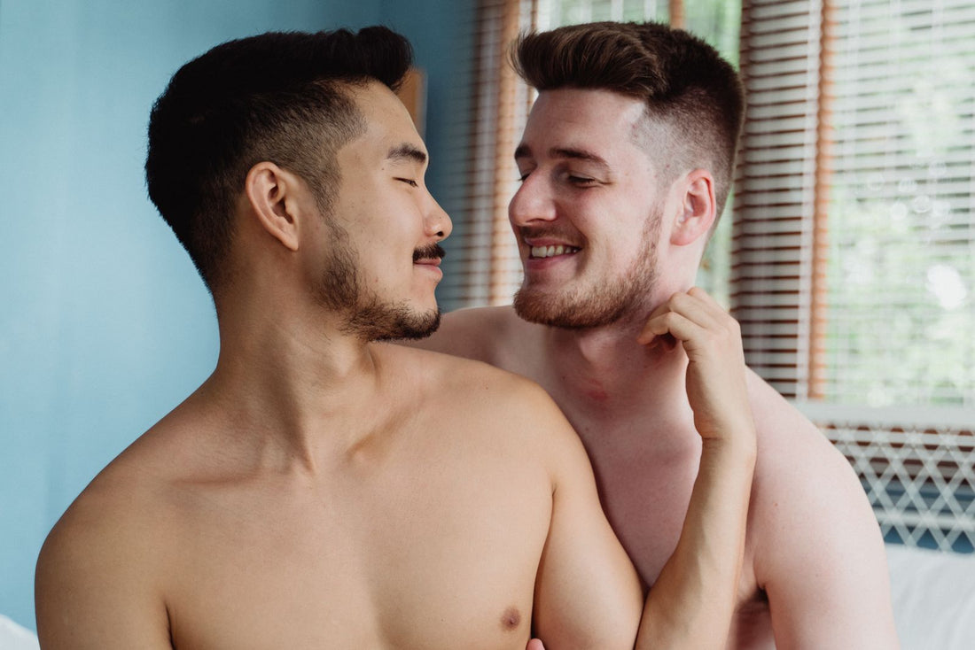 Two men relaxed and close in bed